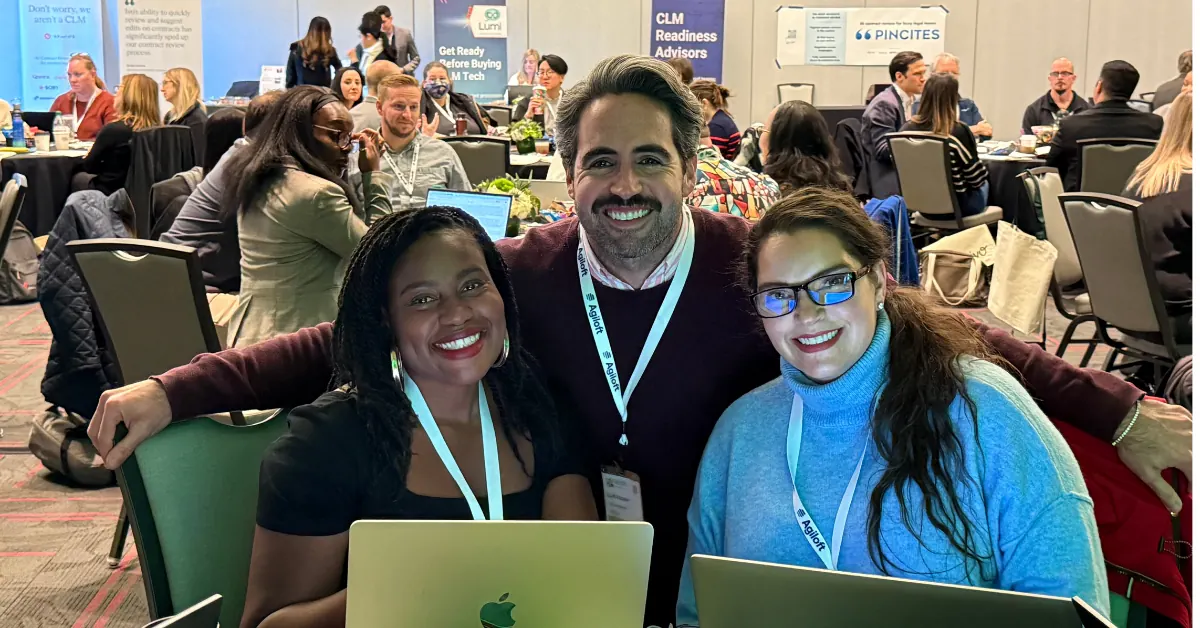 Attendees at a table with laptops open, drafting during a table-group exercise.